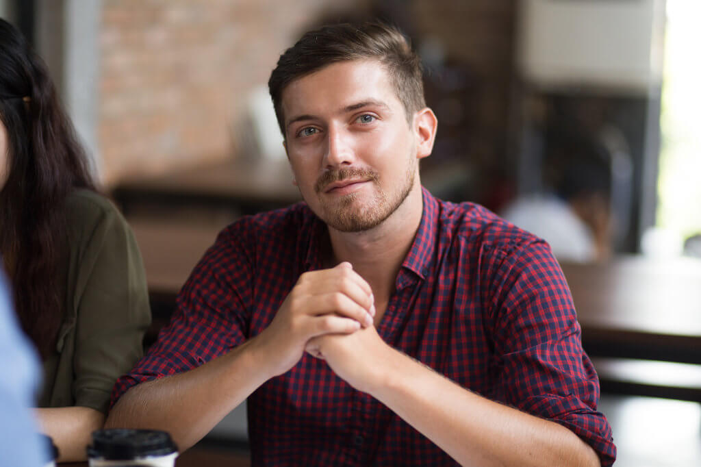 smiling man in plaid shirt experiences alcohol rehab success