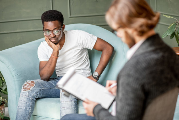 alcoholism treatment in oregon young man talking to male therapist during alcohol rehab in oregon