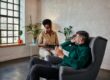 man talking to woman therapist in alcohol rehab program